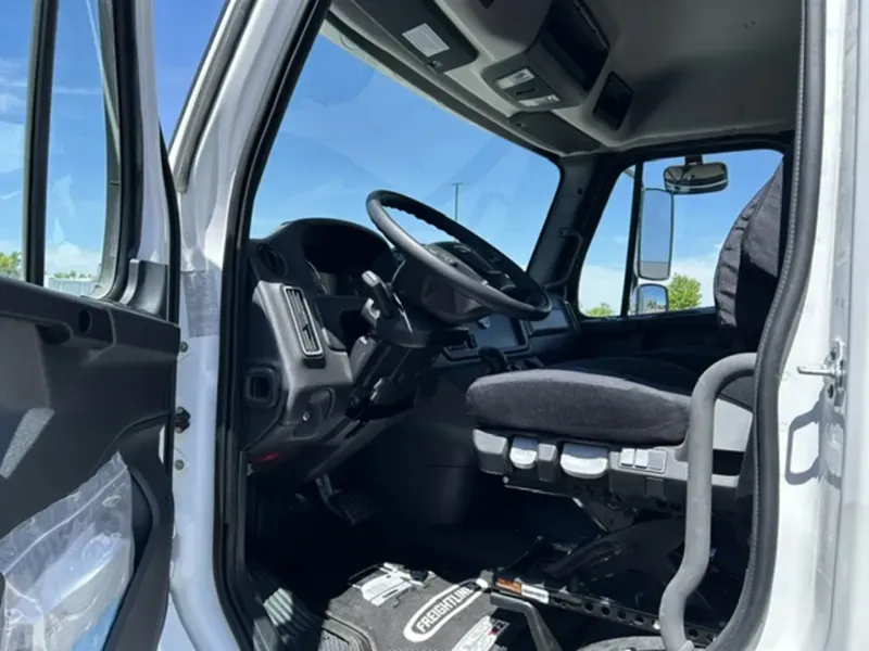 The cab and driver controls of a 2025 Freightliner M2 106, the truck Illyro drivers operate.