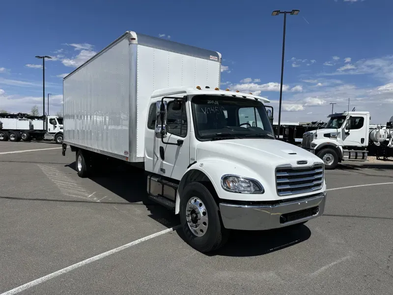 A 2025 Freightliner M2 106 at a loading dock, representative of the modern fleet a quoted load runs on.