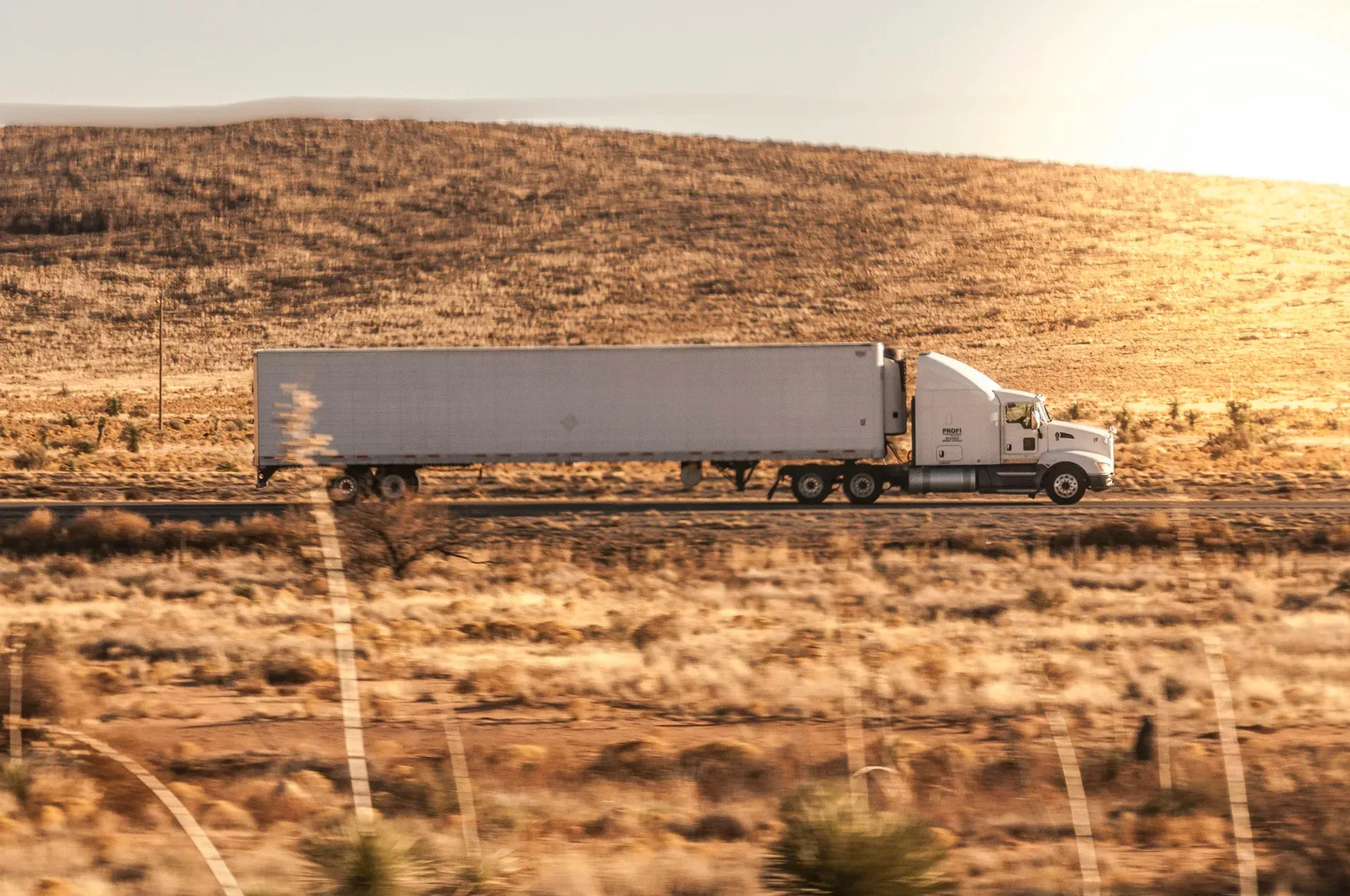 A late-model semi sleeper on the highway, representative of the regional and long-haul lanes Illyro covers.