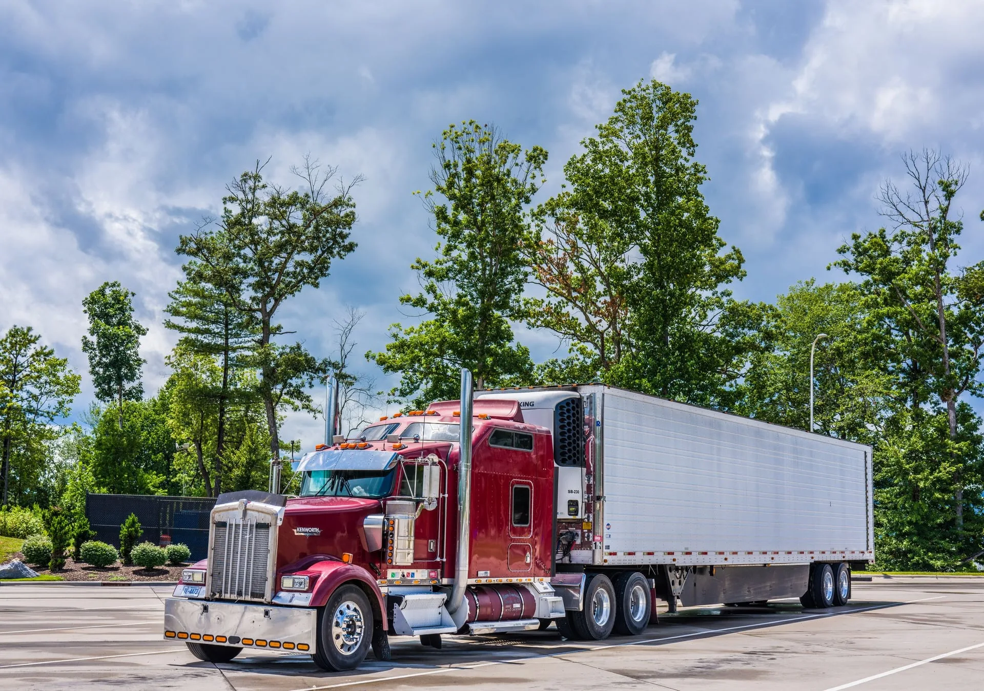 A late-model semi sleeper and trailer parked in a yard, representative of the equipment our drivers operate every day.